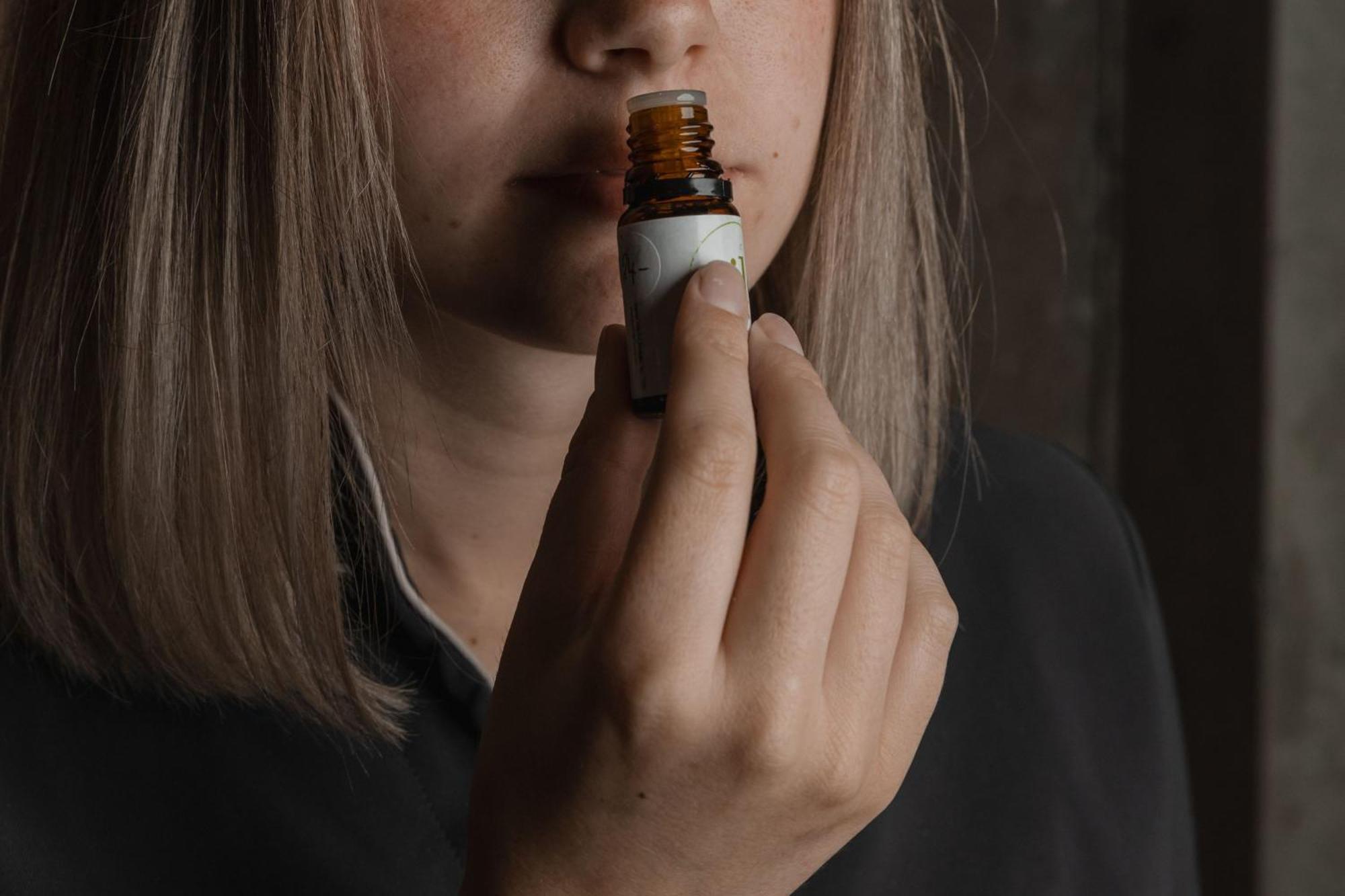 Peppers Silo Hotel Launceston Bagian luar foto A woman smelling a bottle of essential oil